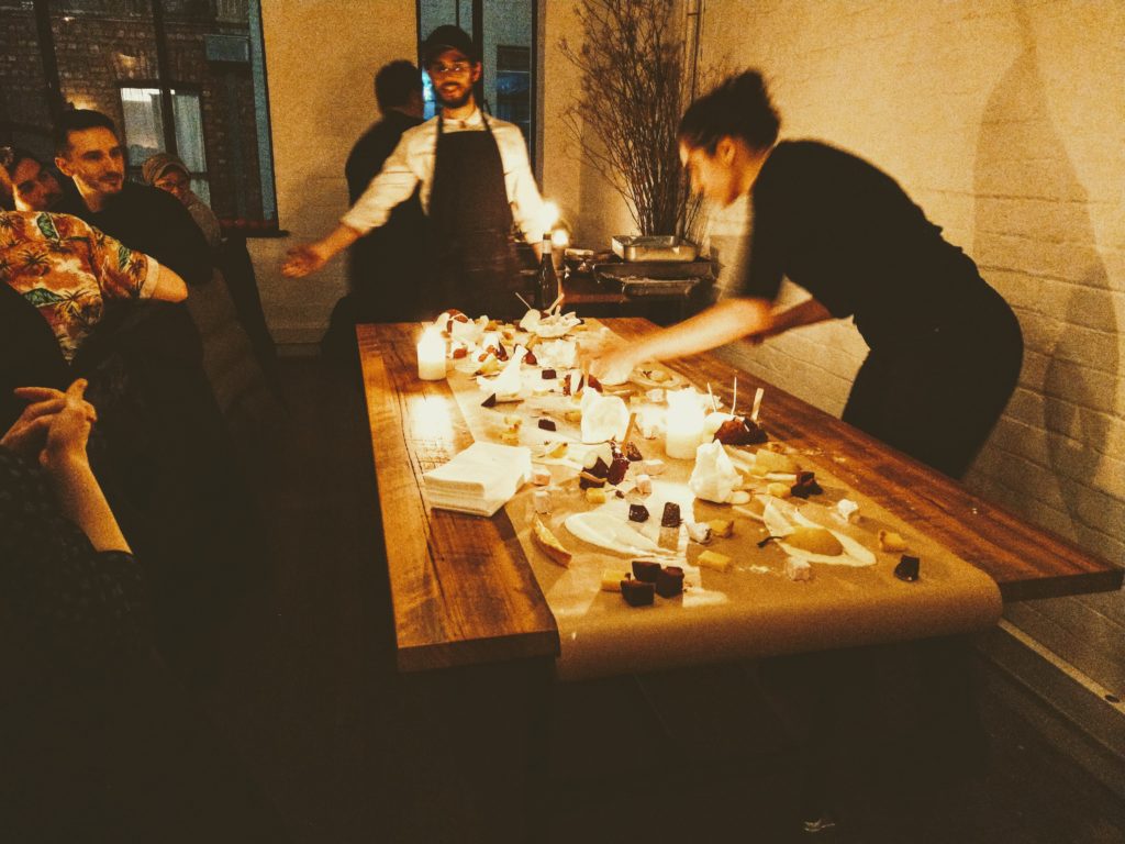 A table set with a display of lots of small desserts spread across it