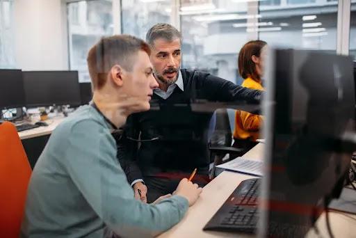 Two men looking at a computer screen