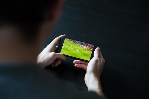 Streaming a Live Football Match on Mobile Phone | by footycomimages