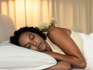 Woman sleeping on Purple Harmony Pillow with arms under head