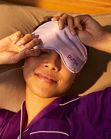 Woman sleeping with purple eye mask in early morning 