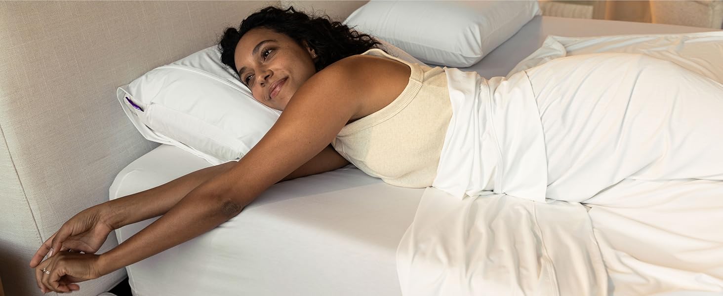 Woman laying down on a Purple Mattress with a Purple Harmony Pillow