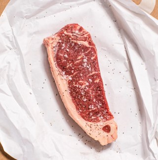 Porter Road NY Strip Steak seasoned on paper