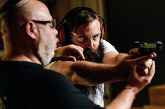 David Kowalsky, owner of Florida Gun Store, teaches Mendy Duchman, gun safety and proper ways to handle a firearm