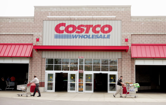 Shoppers leave the Costco Store.