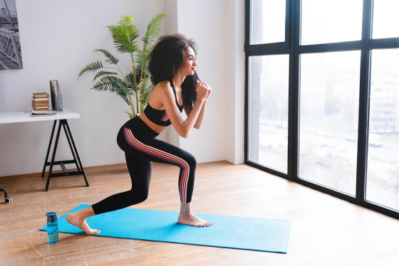 Woman doing curtsy squats