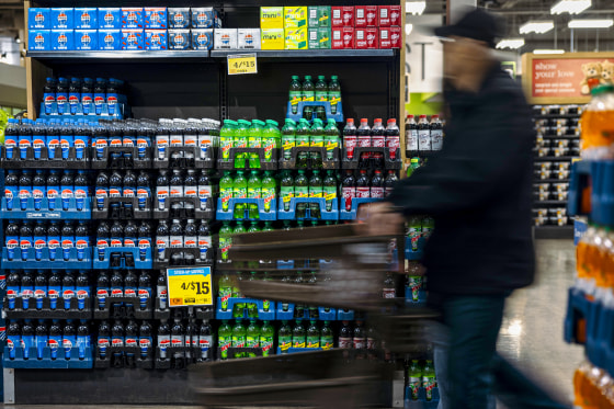 A shopper walks past Pepsi products.