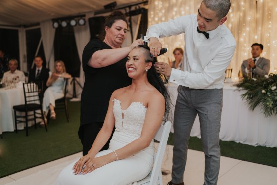 Couple shaving their hair during their wedding