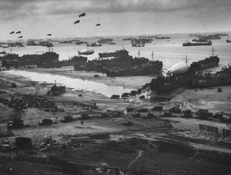 Image: A massive landing and deployment of U.S. troops, supplies and equipment on the day after the victorious D-Day action on Omaha Beach, Arromanches-les-Bains
