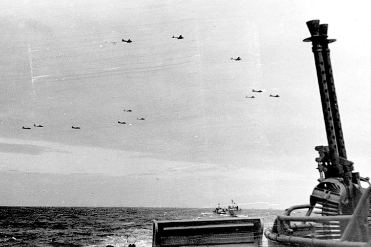 U.S. Navy PT boats cross the English Channel as B-1s, known as Flying Fortresses, fly overhead.
