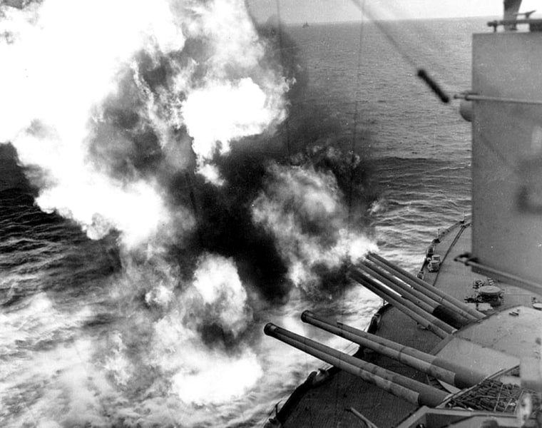 Forward guns of the USS Nevada (BB-36) fire on shoreline positions during the landings on Utah Beach.