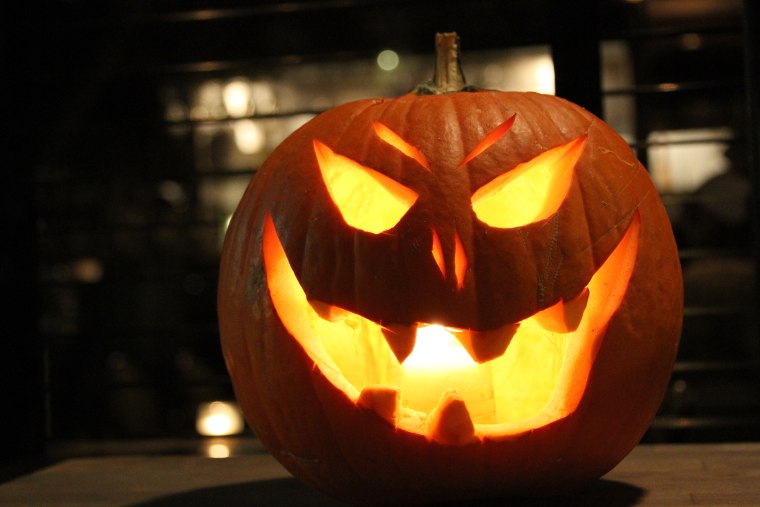 Illuminated Jack-O-Lantern On Table