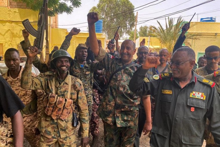 Army chief Abdel Fattah al-Burhan cheering with soldiers as he visits some of their positions in Khartoum in a photo released May 30, 2023. 