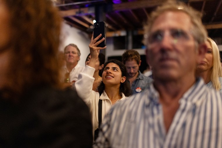 An attendee takes a photo