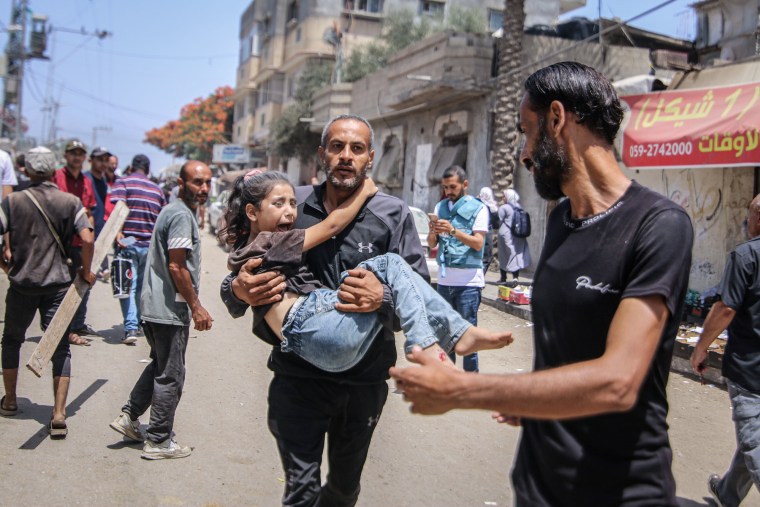 A man carries an injured child away