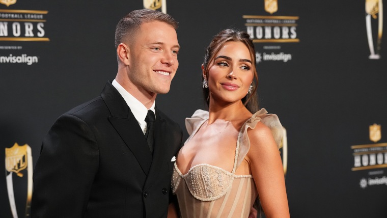 Christian McCaffrey and Olivia Culpo pose for a photo on the red carpet during NFL Honors at the Symphony Hall on February 9, 2023 in Phoenix, Arizona.