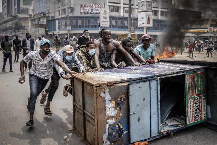 Protesters chant slogans as they use urban furniture as a barricade to clash with Kenya Police officers during an anti-government demonstration called following nationwide deadly protests over tax hikes and a controversial now-withdrawn tax bill in downtown Nairobi, on July 2, 2024. 