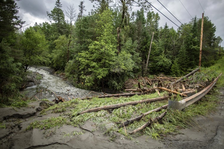 Image: Debris is strewn about a bridge following flooding