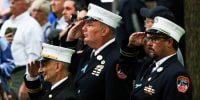 Firefighters salute during the singing of the National Anthem at the annual 9/11 Commemoration Ceremony on Sept. 11, 2022, in New York.