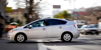 A Toyota Prius crossing a street.