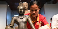 Buddhist monks in the Cambodian capital Phnom Penh chanted blessings and threw flowers on July 4 in a welcoming ceremony for 14 trafficked artefacts that were repatriated by a prestigious New York museum. 