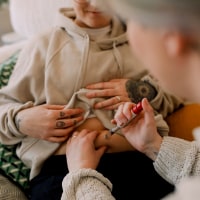 Lesbian women doing IVF test with syringe at home