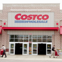 Shoppers leave the Costco Store.