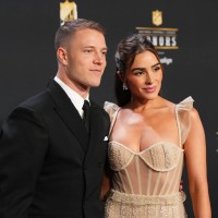 Christian McCaffrey and Olivia Culpo pose for a photo on the red carpet during NFL Honors at the Symphony Hall