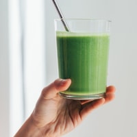 Young Woman Drinking Green smoothie For Cleanse Diet