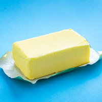 Single butter stick on blue background.