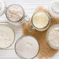 Different flour jars, wheat, corn, rye, oats, spelt, flax