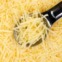 Shredded Parmesan cheese with spoon