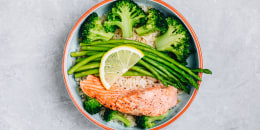 Healthy lunch bowl salmon and broccoli with asparagus and rice