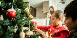 A Japanese family decorating the Christmas tree
