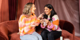 two women who are sisters, laughing while applying skincare products