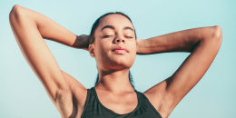 smiling woman standing with closed eyes 