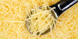 Shredded Parmesan cheese with spoon
