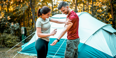 Husband and wife camping in beautiful nature. Child care during the covid 19 pandemic.