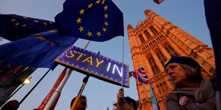 Image: Banners, Union and EU flags are displayed outside the Houses of Parliament in London on Oct. 22, 2019, as MPs debate the second reading of the Government's European Union (Withdrawal Agreement) Bill.