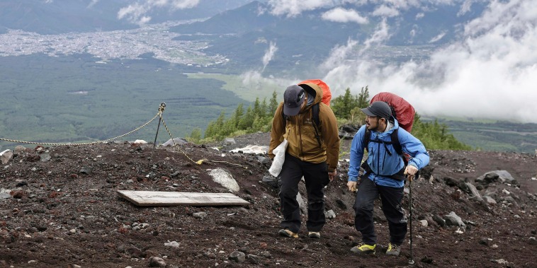 Park rangers on Japan’s sacred Mount Fuji officially started this year’s climbing season about 90 minutes before sunrise on Monday, levying new trail fees and limiting hiker numbers to curb overcrowding.