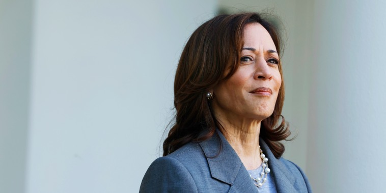 Kamala Harris looks on as Second gentleman Doug Emhoff speaks in the Rose Garden of the White House.