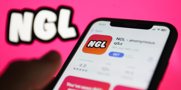NGL on App Store displayed on a phone screen and NGL website displayed on a screen in the background 