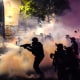 Federal officers deploy tear gas and less-lethal munitions while dispersing a crowd of about a thousand protesters in front of the Mark O. Hatfield U.S. Courthouse