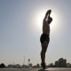 Iranian man jumps into a pool during the heatwave in Tehran