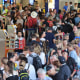 Passengers queuing at the departures hall at Frankfurt's International Airport on July 25, 2024.