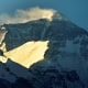 Wind blows snow off the summit at sunrise of the world's highest mountain Mount Everest, also known as Qomolangma, in the Tibet Autonomous Region