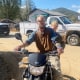 Stewart Cody with a child on his motorcycle