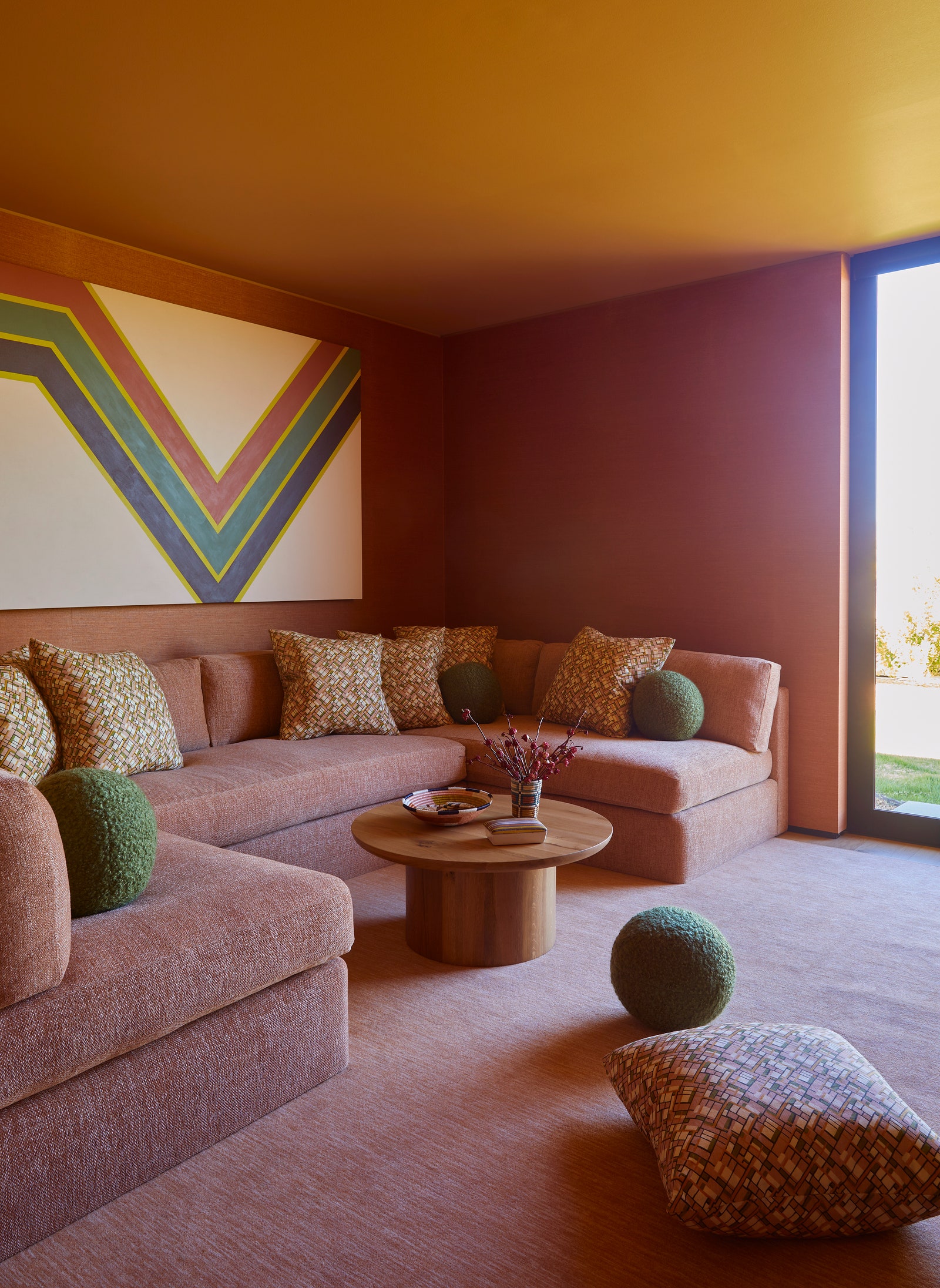 Josh Greene swathed this Ushaped sofa in cantaloupecolored chenille—a fabric that may supplant cream boucl in 2024.