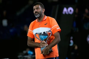 AP Photo : Rohan Bopanna of India holds his trophy after he and partner Matthew Ebden of Australia defeated Simone Bolelli and Andrea Vavassori of Italy in the men's doubles final at the Australian Open 2024 at Melbourne Park, Melbourne on January 27, 2024.