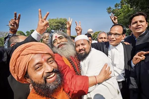 Photo: PTI : Momentous: Hindus and Muslims celebrate the Ayodhya verdict outside the Supreme Court in New Delhi in 2019